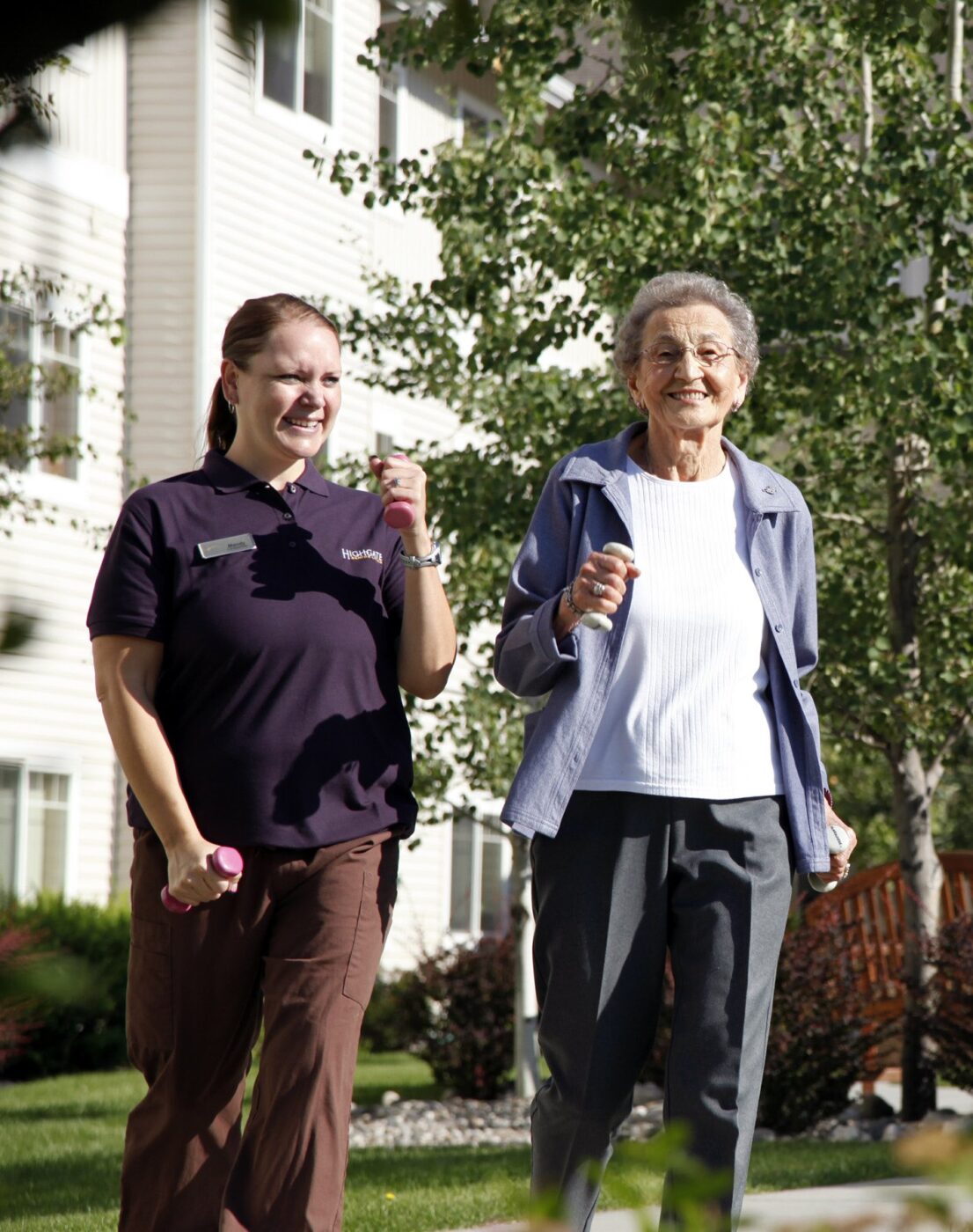 Resident and staff enjoying a walk outdoors