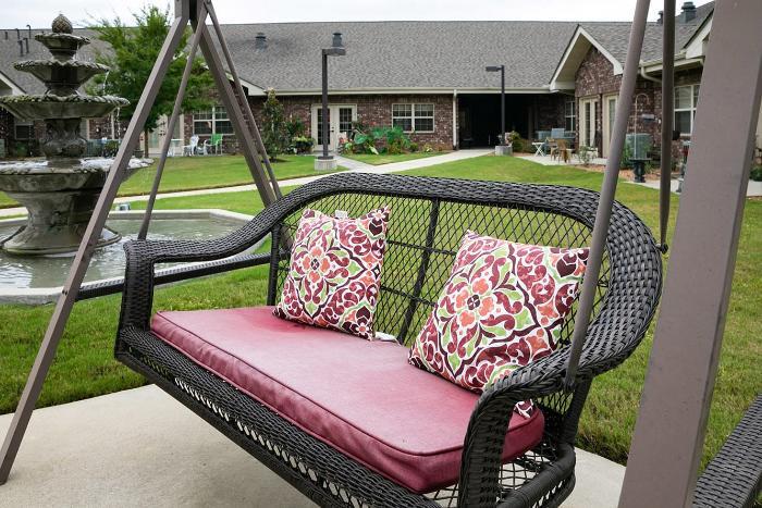 Outdoor seating area with a swing and fountain