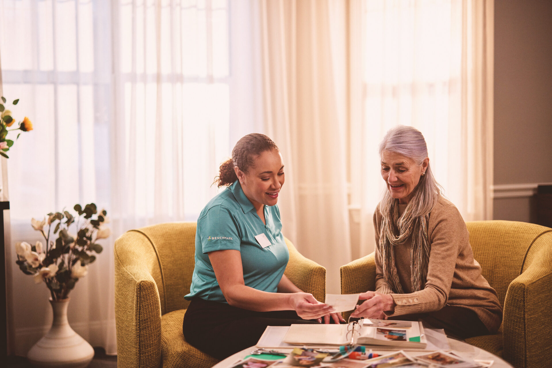 Staff member showing photo album to a resident