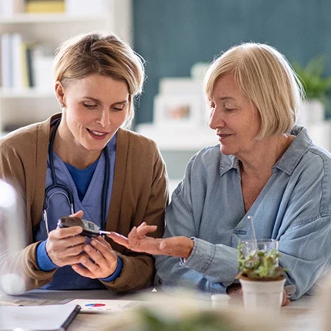Nurse assisting a senior resident with health monitoring
