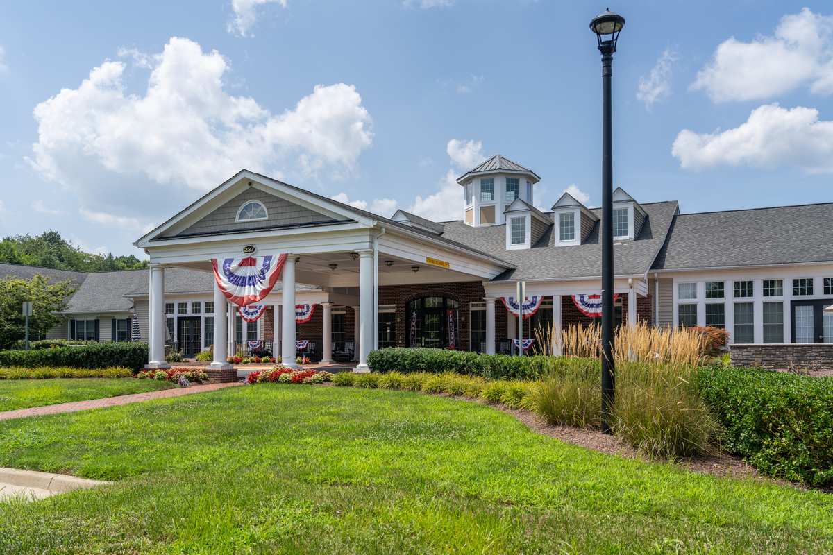 Exterior view of a senior living facility with patriotic decor