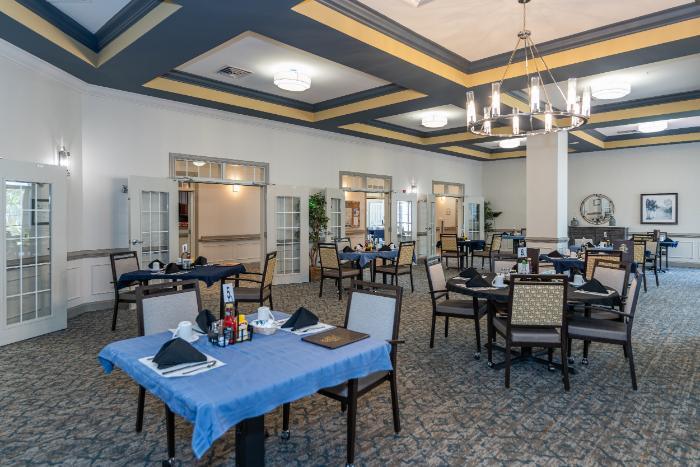 Dining area set up for residents with tables and chairs