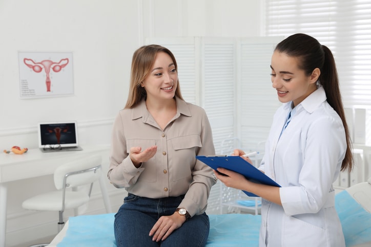 Healthcare professional consulting with a patient in a clinic room