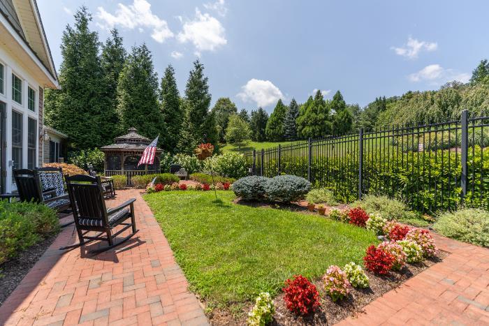 A peaceful outdoor garden area with seating and flowers