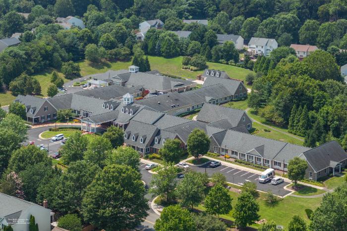 Aerial view of a senior living community with landscaped grounds