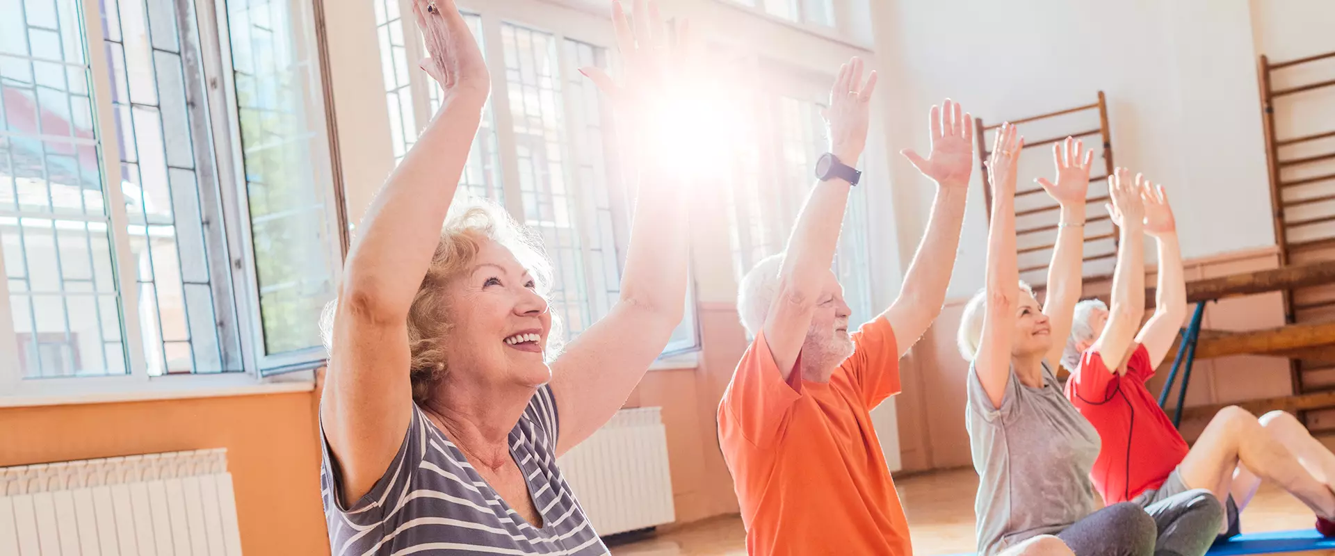 Residents participating in a seated exercise class