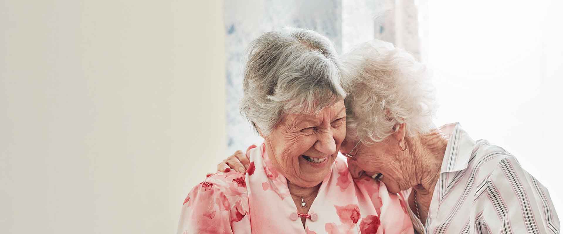 Two laughing residents enjoying a moment together
