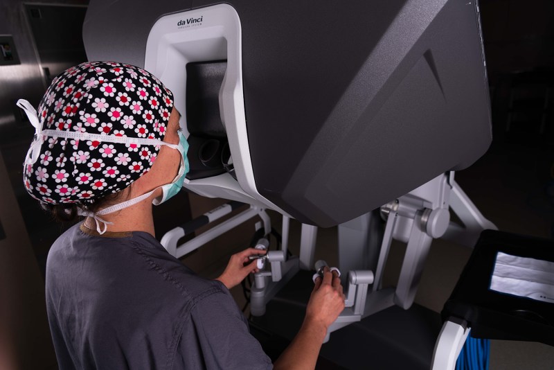 Medical professional operating a surgical robot