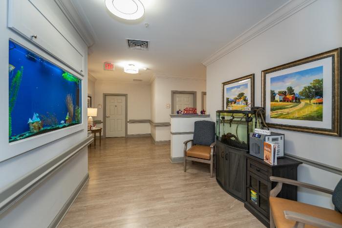 Bright interior hallway with aquarium and seating