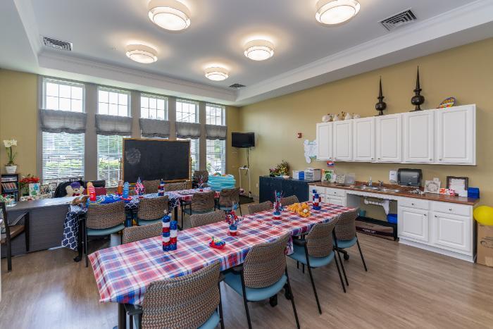 Common area decorated for an event with tables and chairs