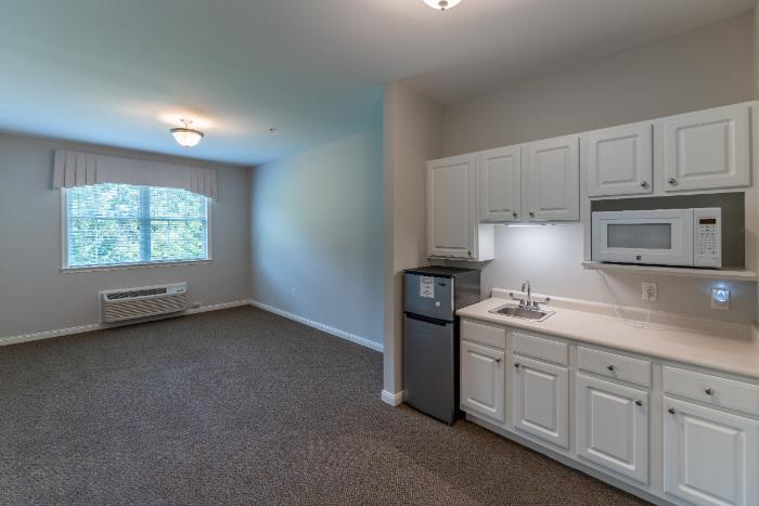 Bright interior of a resident room with kitchenette