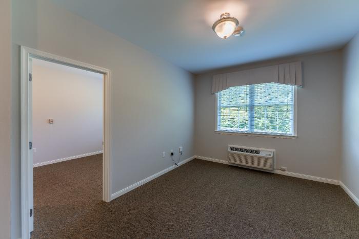 Interior view of a private resident room with natural light