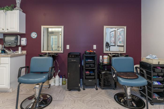Hair salon area with chairs and mirrors