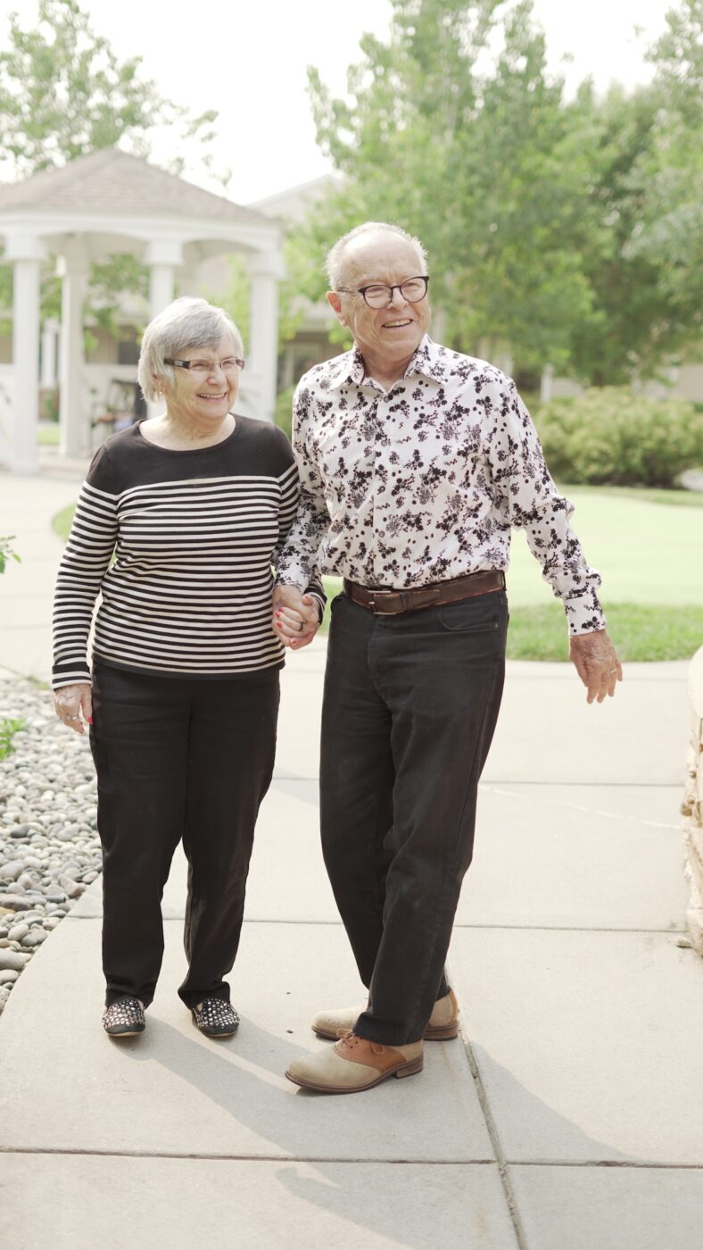 A couple walking together in a landscaped area