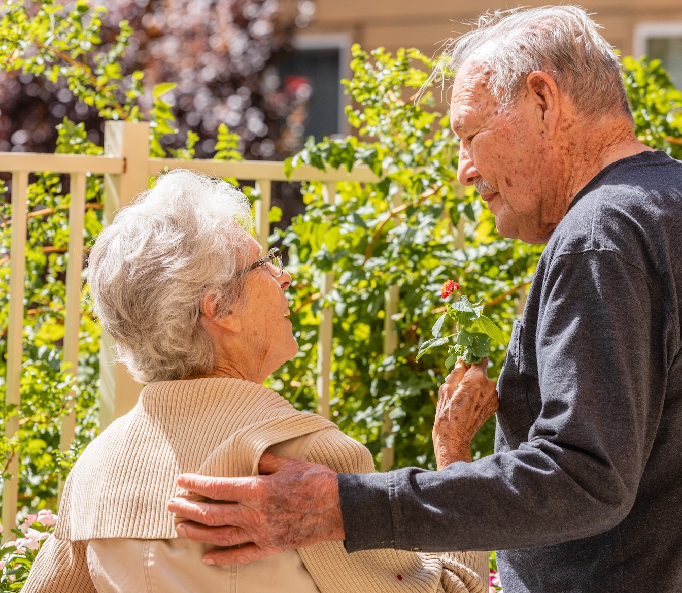 Two residents enjoying time together in a garden