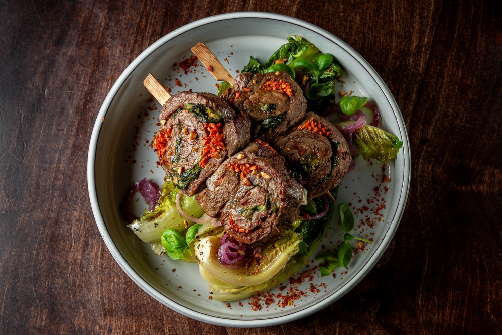 Plate of meat rolled with vegetables and herbs
