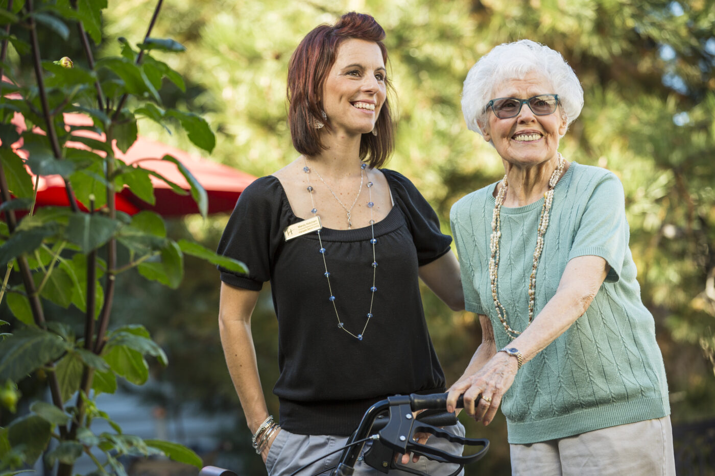 Staff member assisting a resident in a garden area