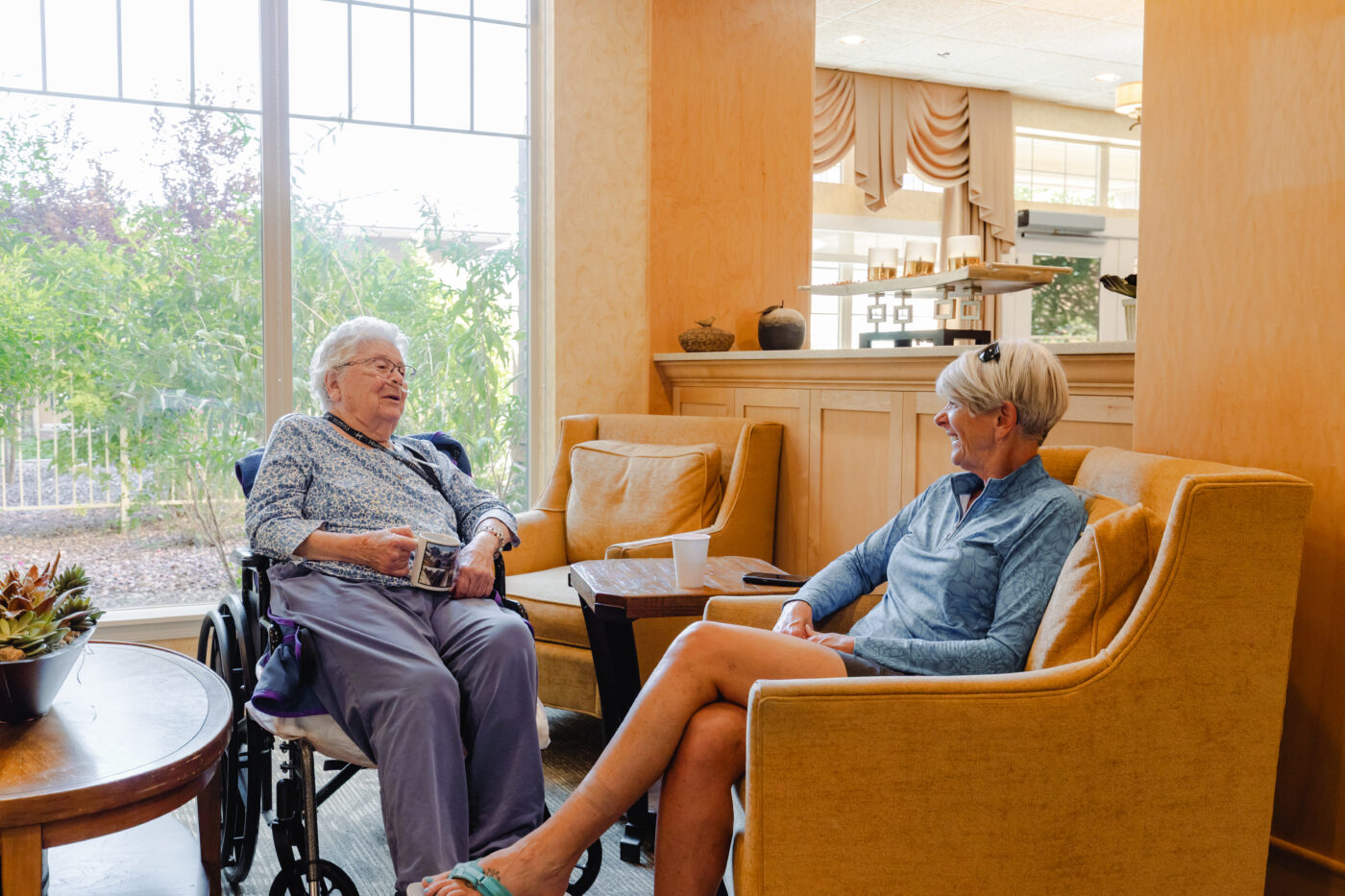 Residents chatting in a comfortable lounge area
