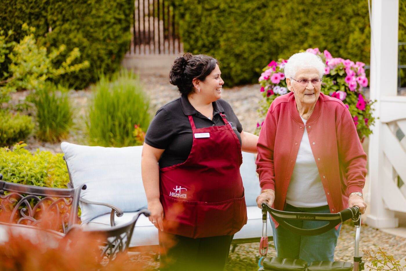 Staff member assisting a resident in the garden