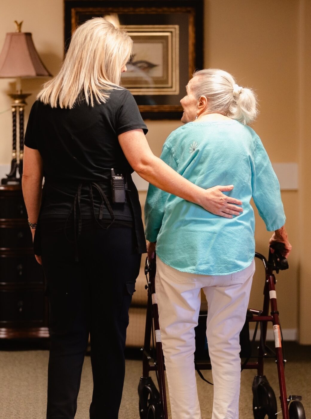 Staff assisting a resident in an indoor common area