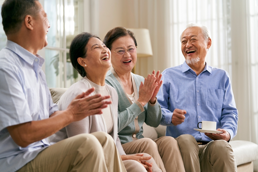 Residents enjoying a lighthearted conversation in a lounge