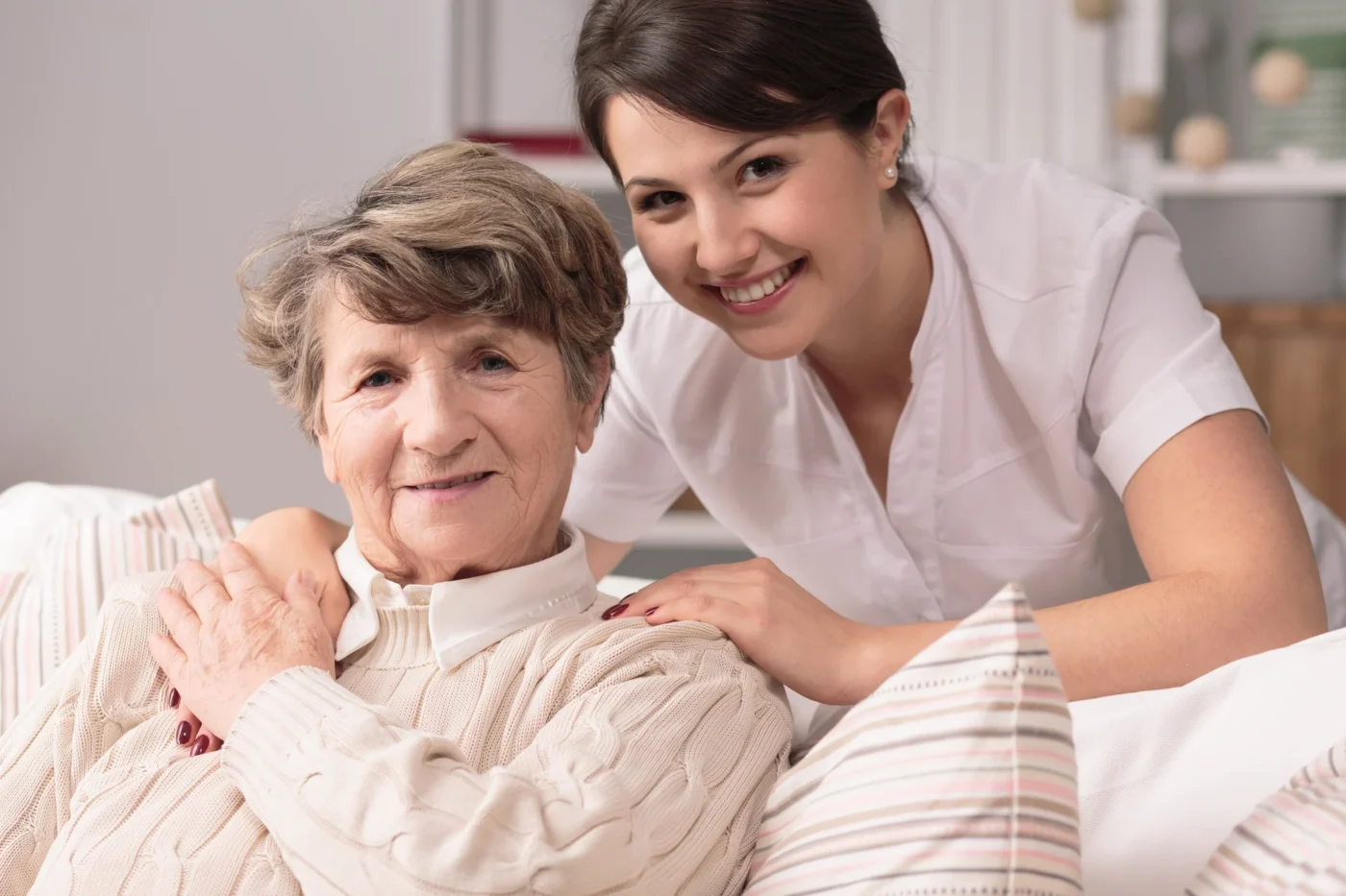 A staff member smiling with a senior resident