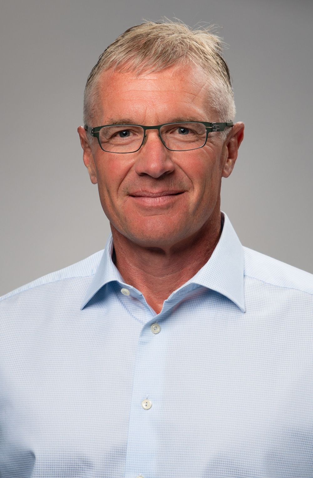 Portrait of a man in a light blue shirt