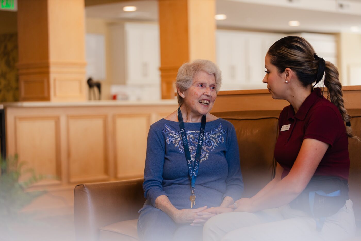 A resident conversing with staff in the lobby