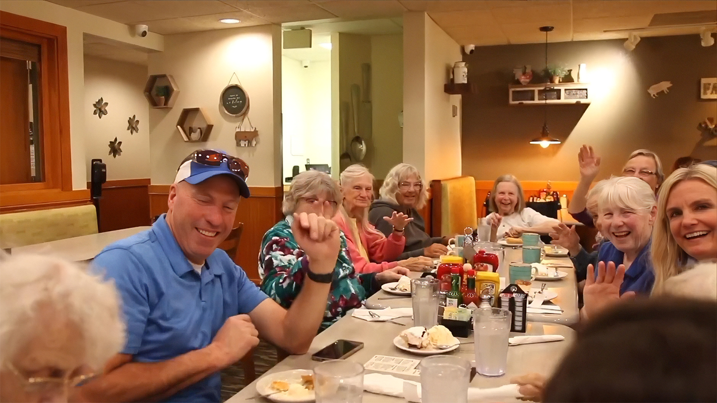 Residents and staff enjoying a meal together