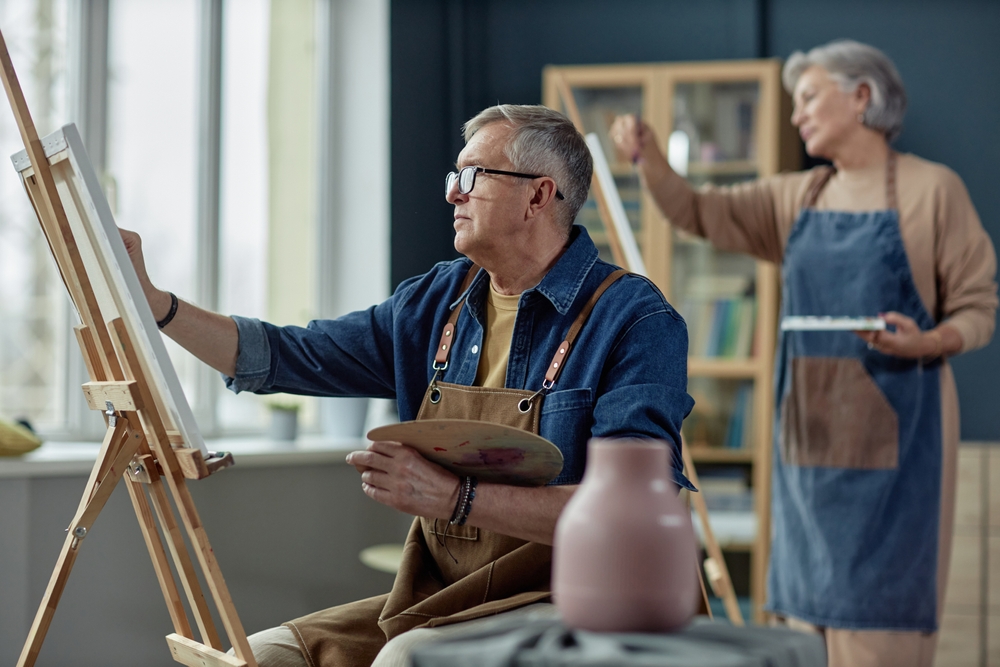 Residents enjoying a painting activity in an art class