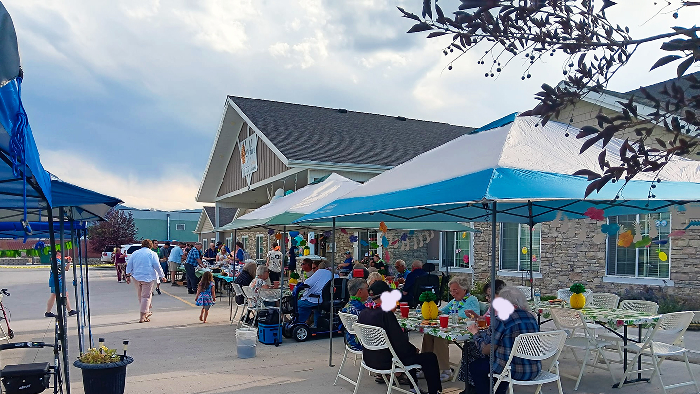 Residents enjoying an outdoor activity with tables and tents