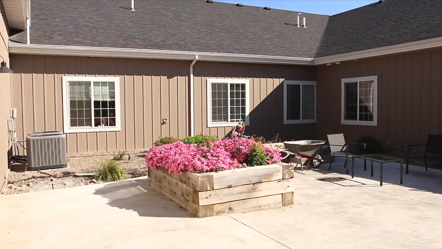 A landscaped outdoor space with flowers and seating
