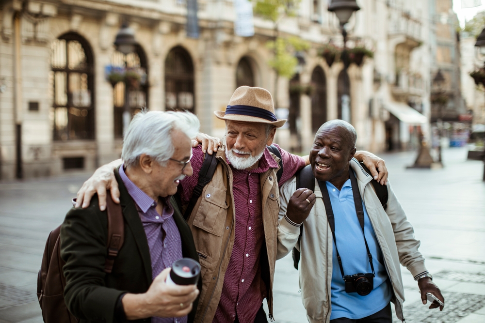 Three residents enjoying a conversation outdoors