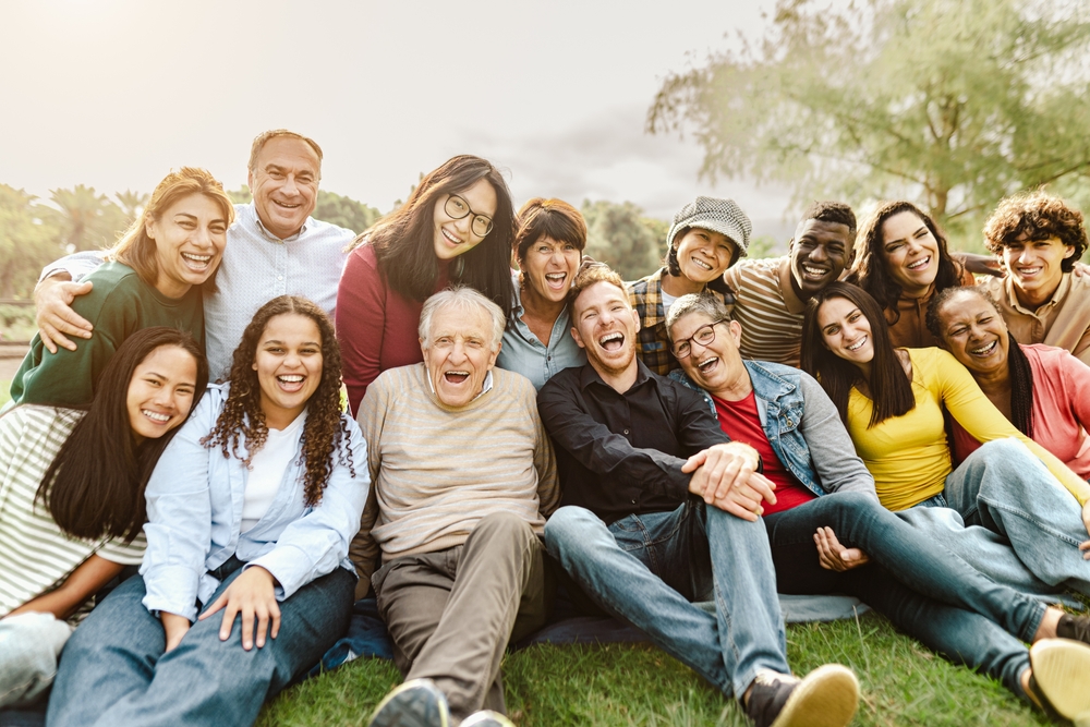 Group of smiling residents and staff outdoors