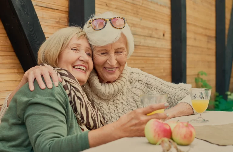 Two senior women enjoying time together with drinks