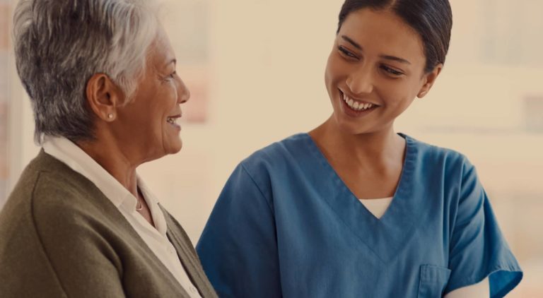 Caregiver smiling with a resident