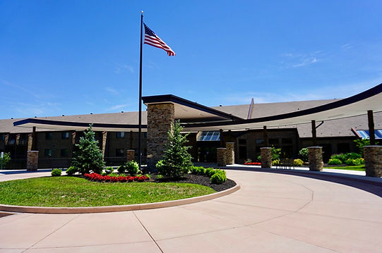 Building exterior of Brookwood Retirement Community with landscaping
