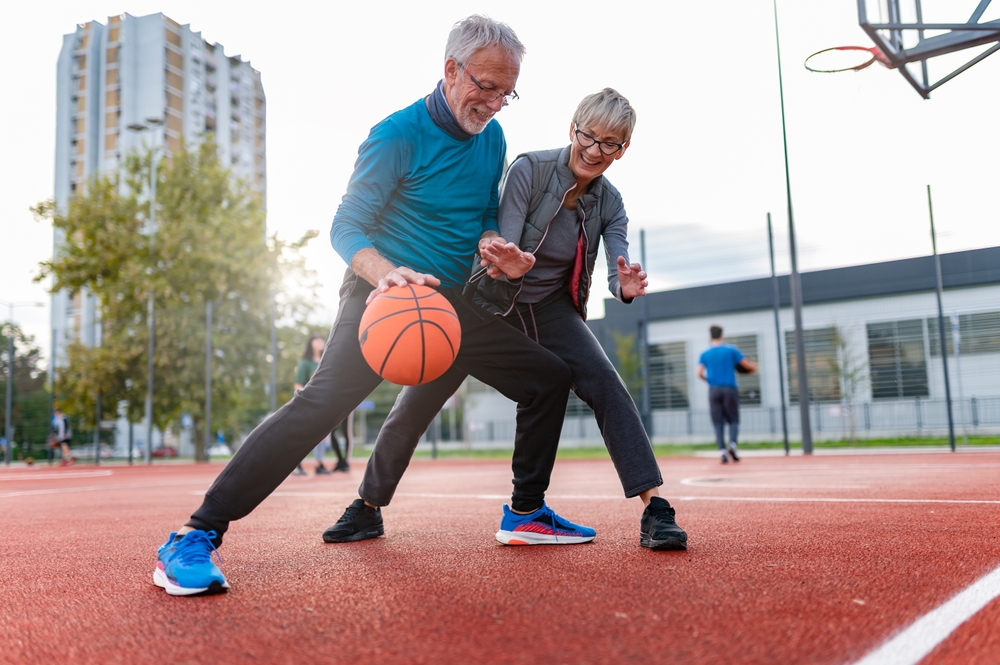 Senior residents playing basketball on an outdoor court