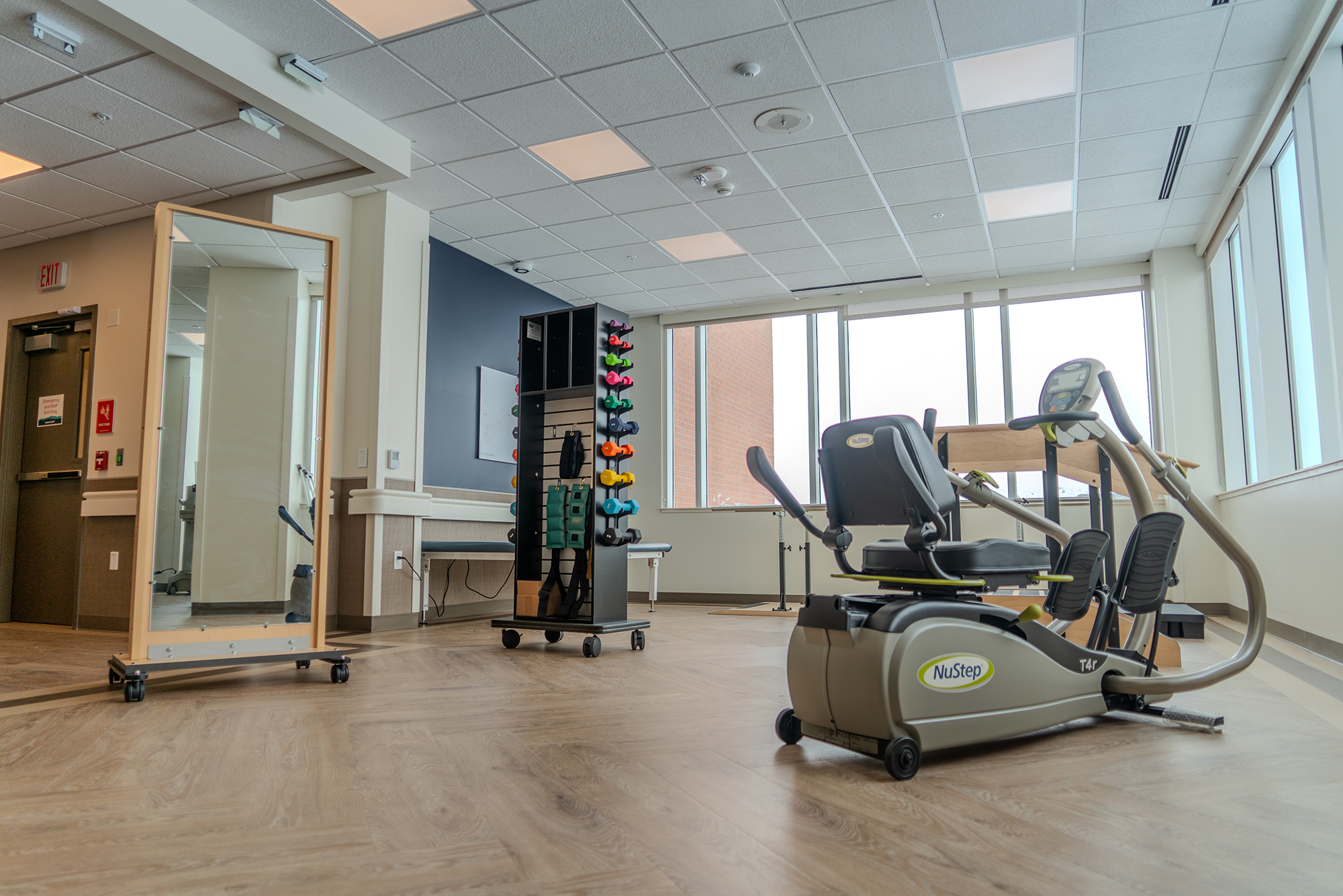 Therapy room with fitness equipment and mirrors