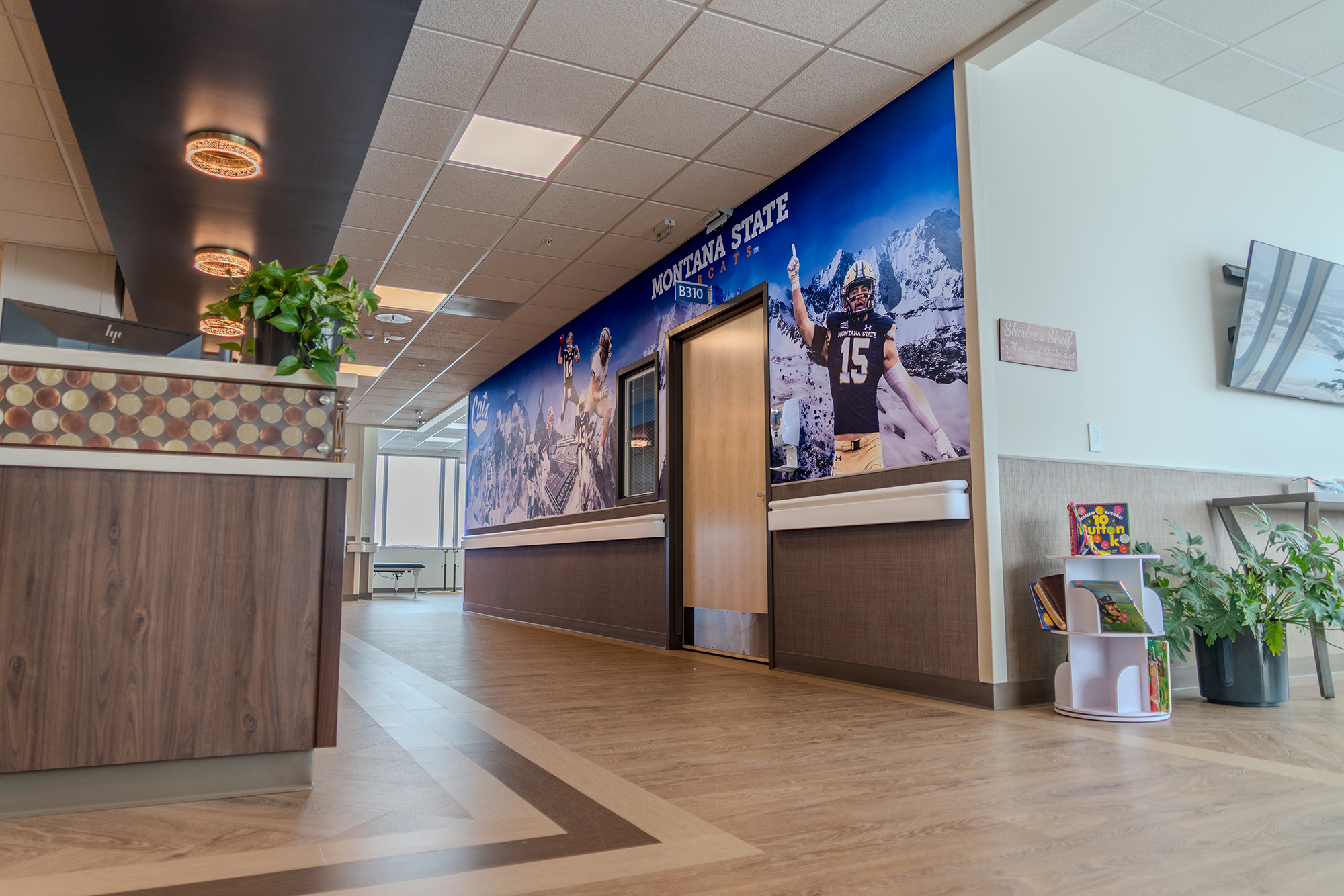 Interior hallway with decorative murals and reception area