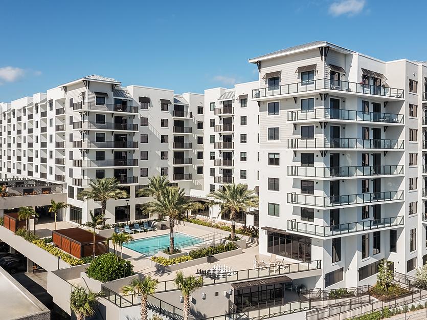 Aerial view of a modern senior living facility with pool