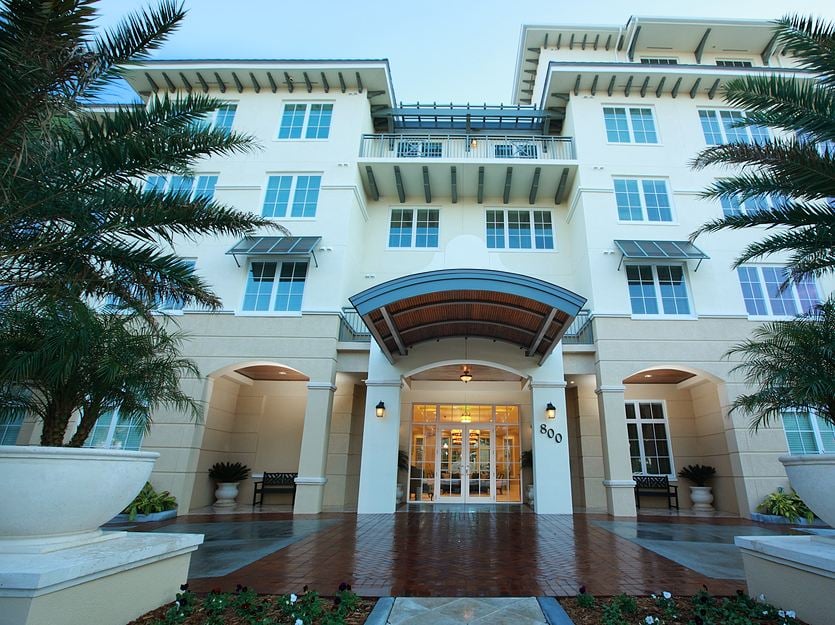 Exterior view of a senior living facility with gardens