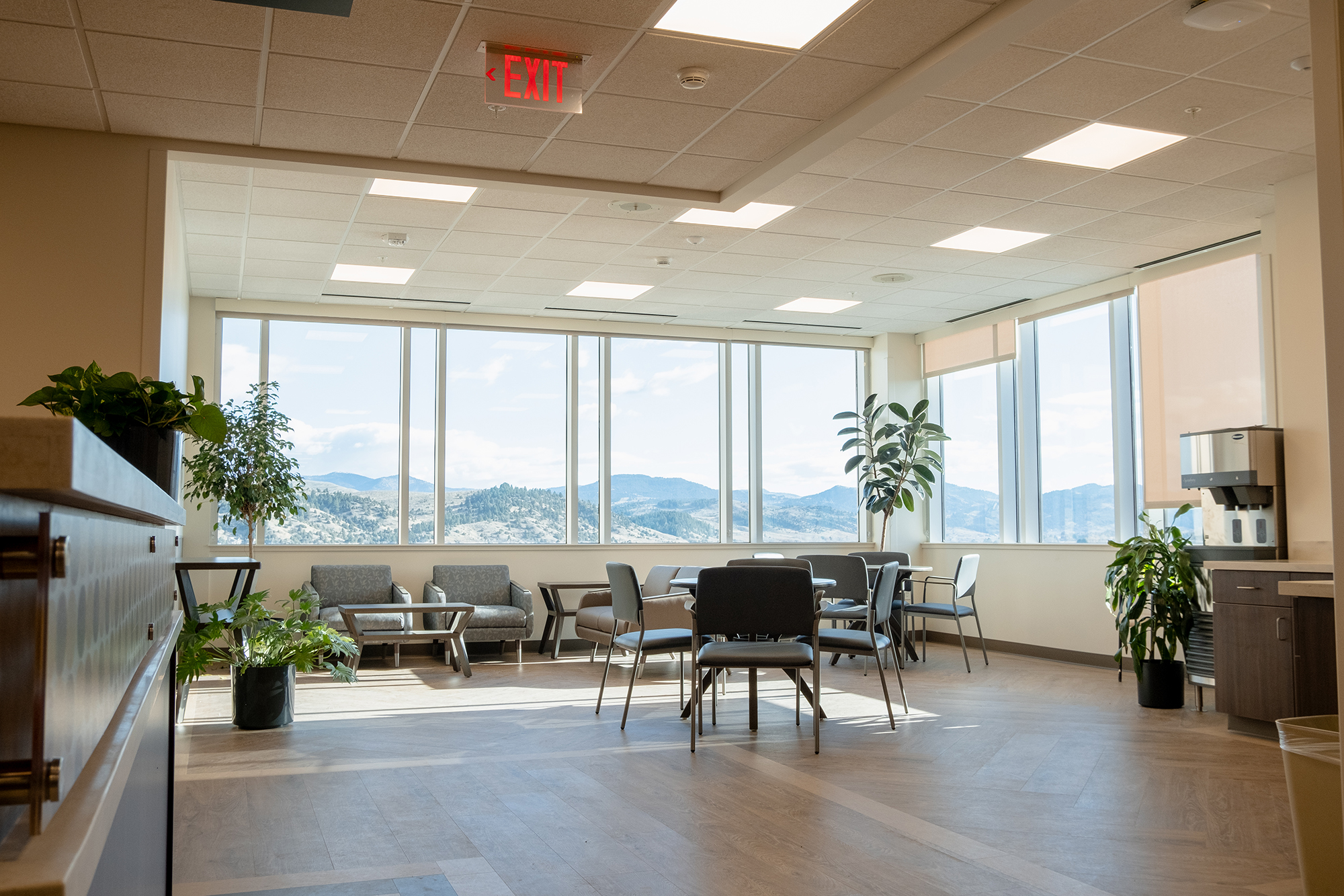 Bright common area with large windows and seating