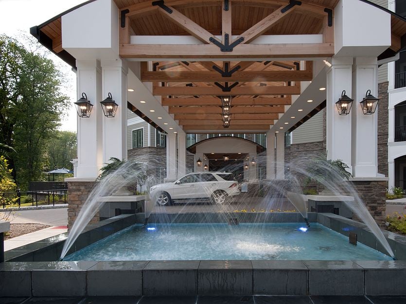 Front entrance of a senior living facility with fountain