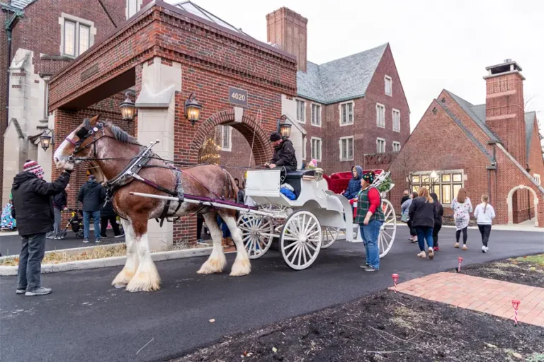 A horse-drawn carriage in front of a senior living facility