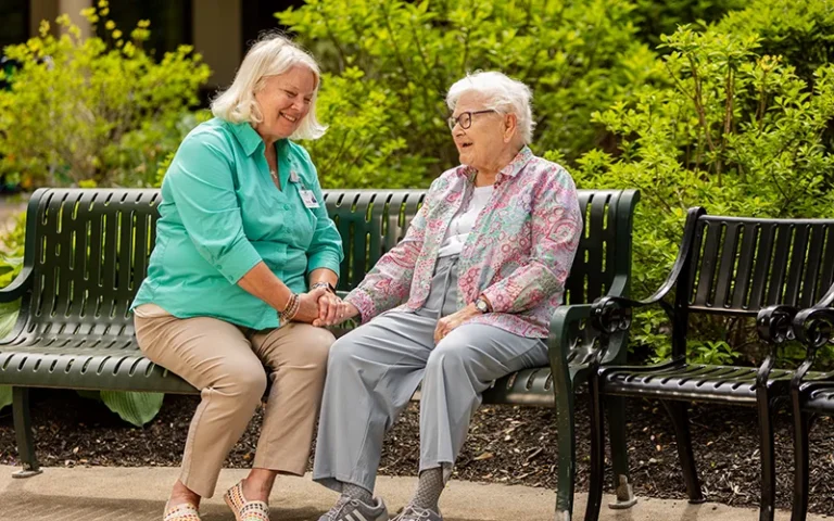 Senior resident and staff member enjoying time together outdoors