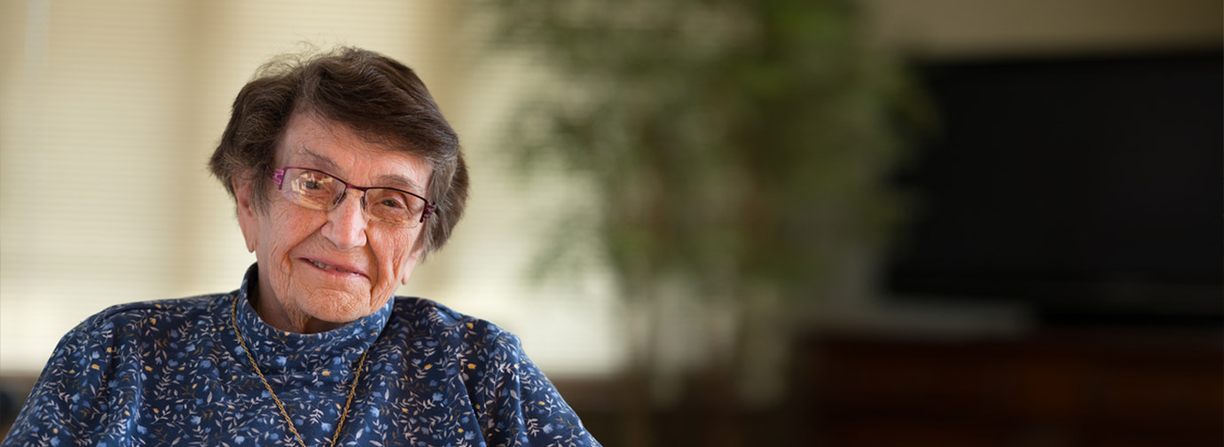 A resident smiling in a common area