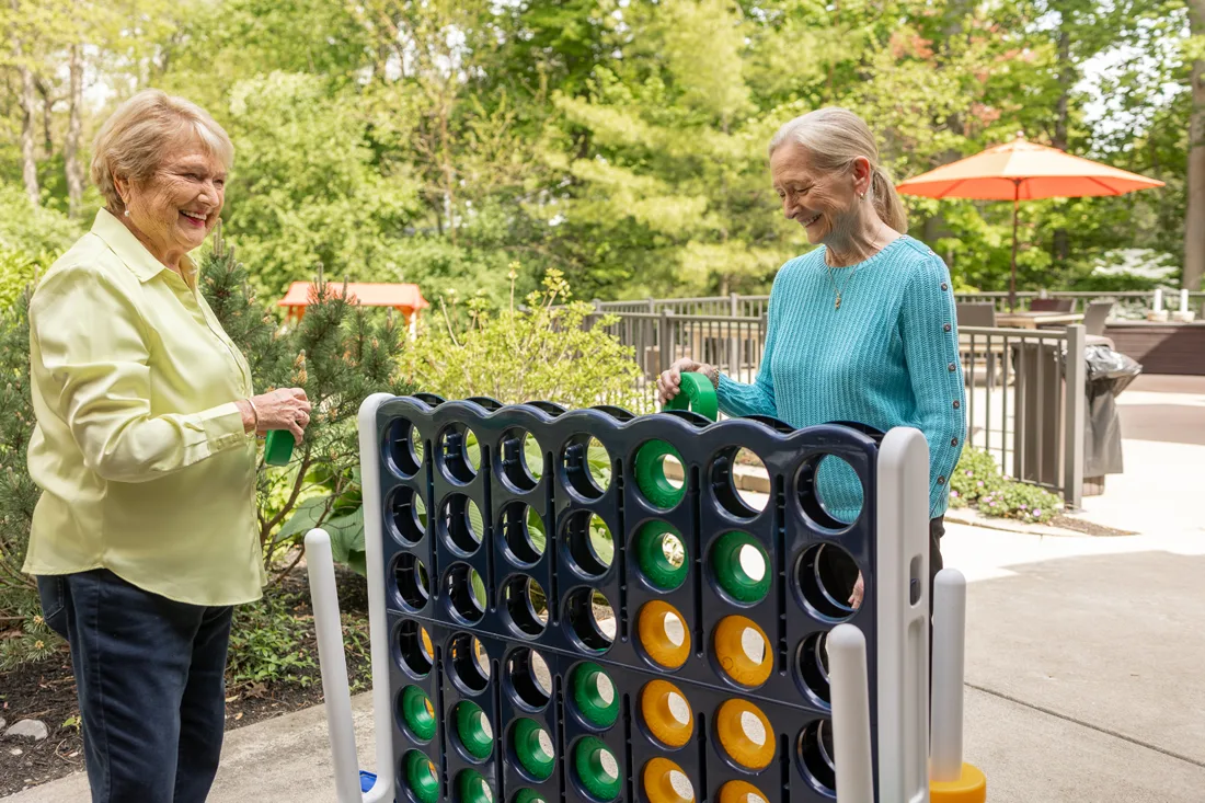 Two residents enjoying a game outside