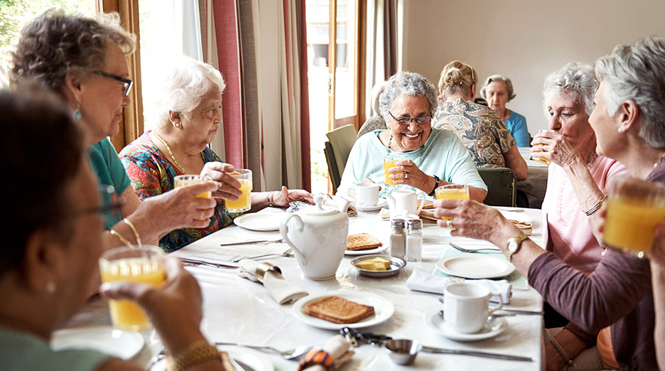 Residents enjoying breakfast together in a dining area