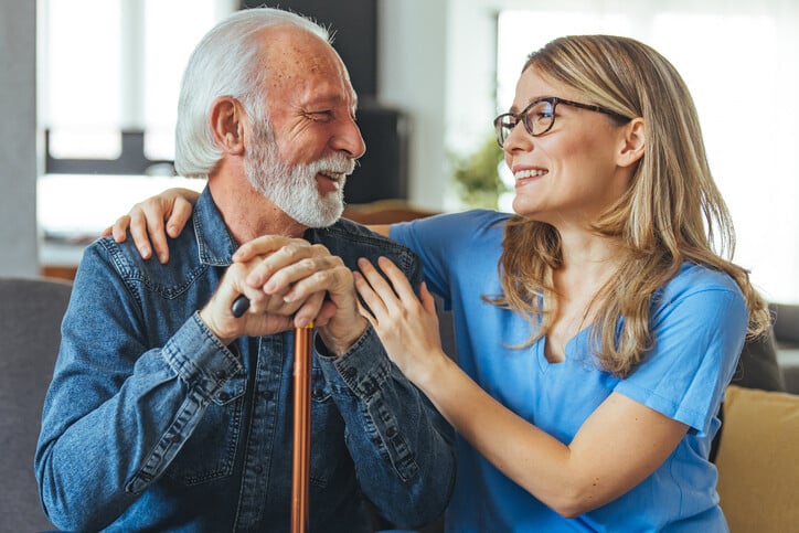 Staff member with senior resident sharing a joyful moment